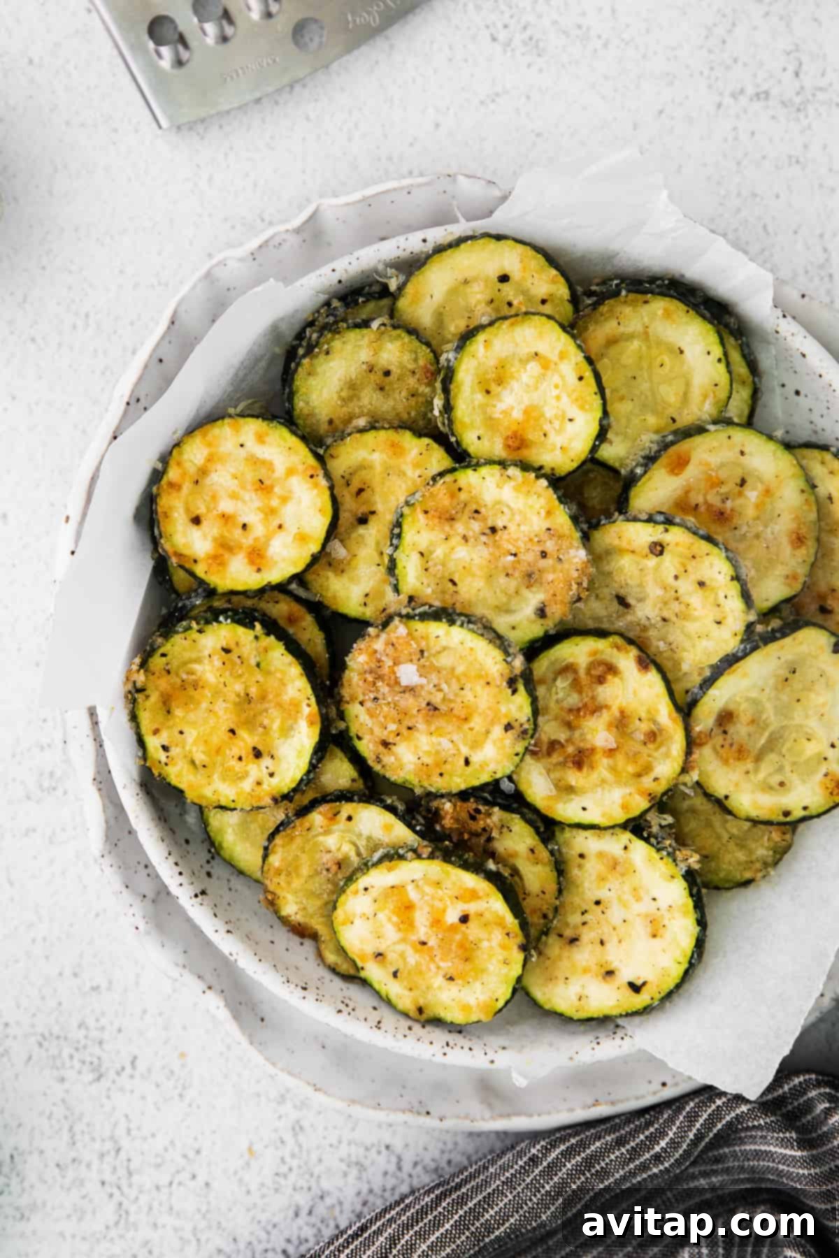 Crispy air fryer zucchini in a bowl, looking golden brown and ready to eat.
