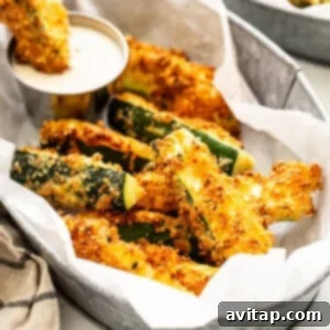 Crispy Air Fryer Zucchini 2 Crispy air fryer zucchini fries in a serving basket.