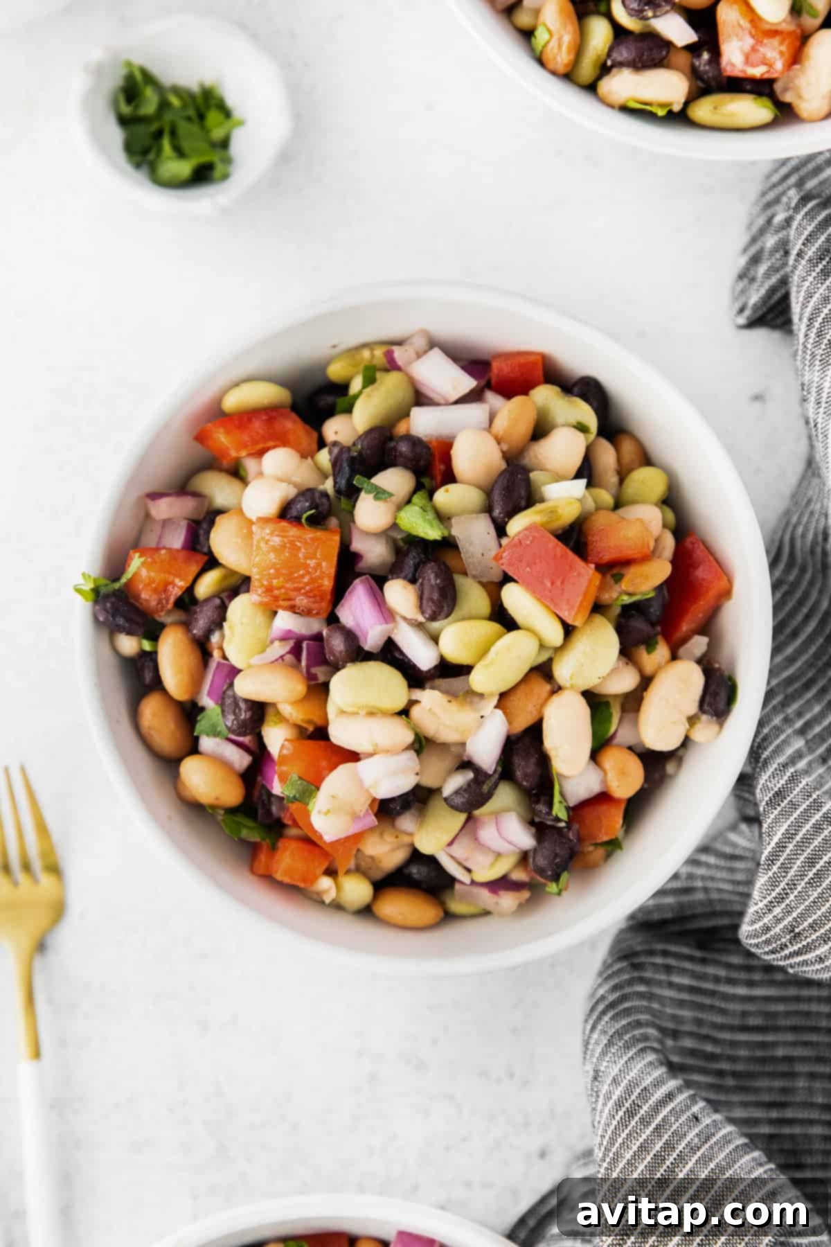A small, elegant bowl of fresh bean salad, showcasing its vibrant colors and textures, perfect as a healthy side dish or light lunch.
