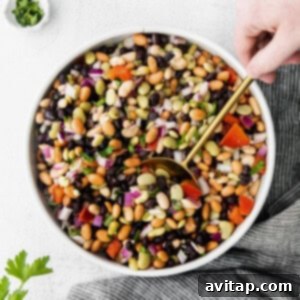 A vibrant and fresh bean salad in a bowl, ready to be enjoyed. Highlighted by a bright, clean presentation.