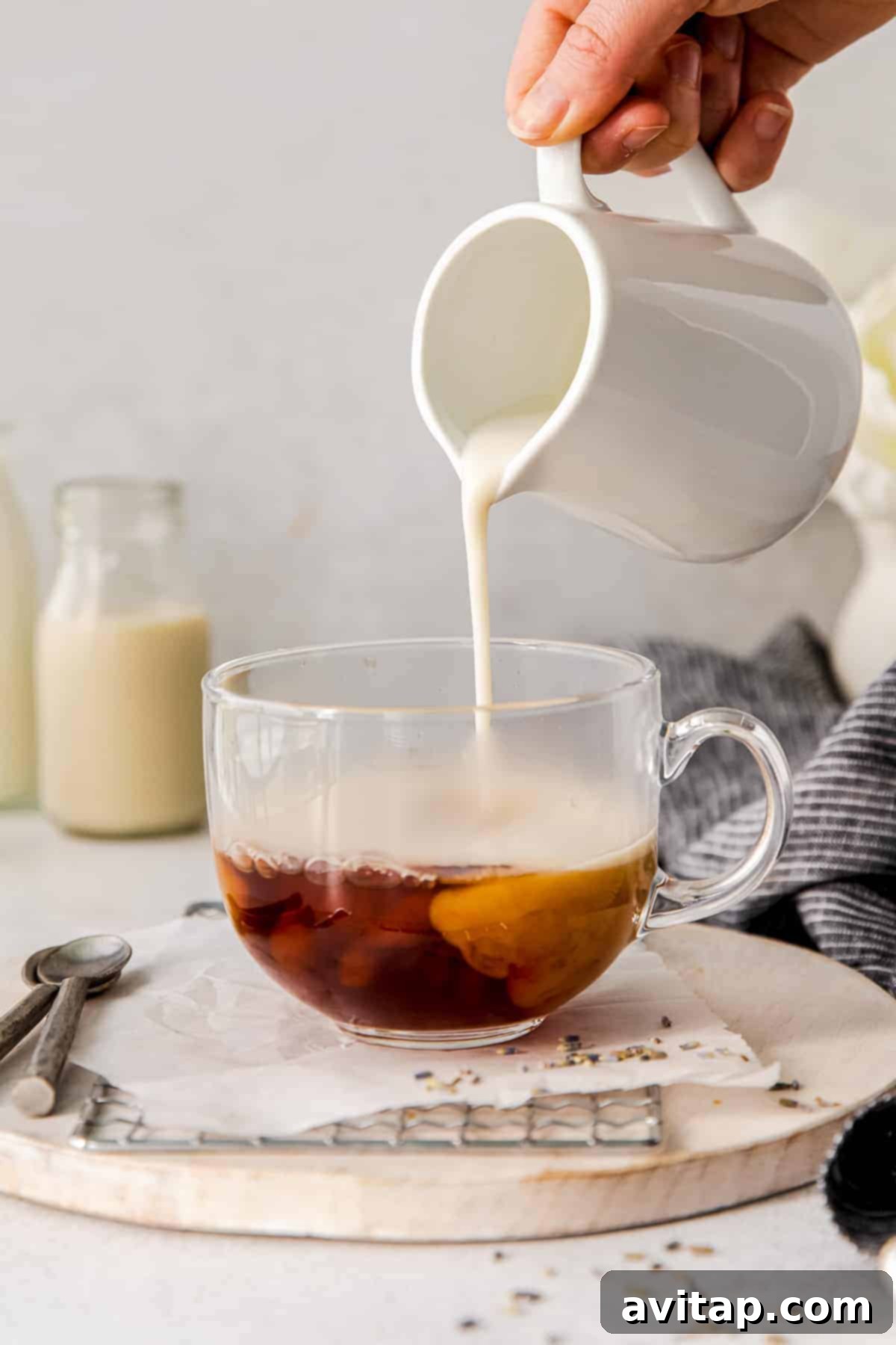 Start your day with this deliciously easy London fog drink! This latte is made with earl grey tea, your favorite steamed milk and slightly sweetened. Steamed milk being poured into a mug of freshly steeped Earl Grey tea, creating a beautiful London Fog.