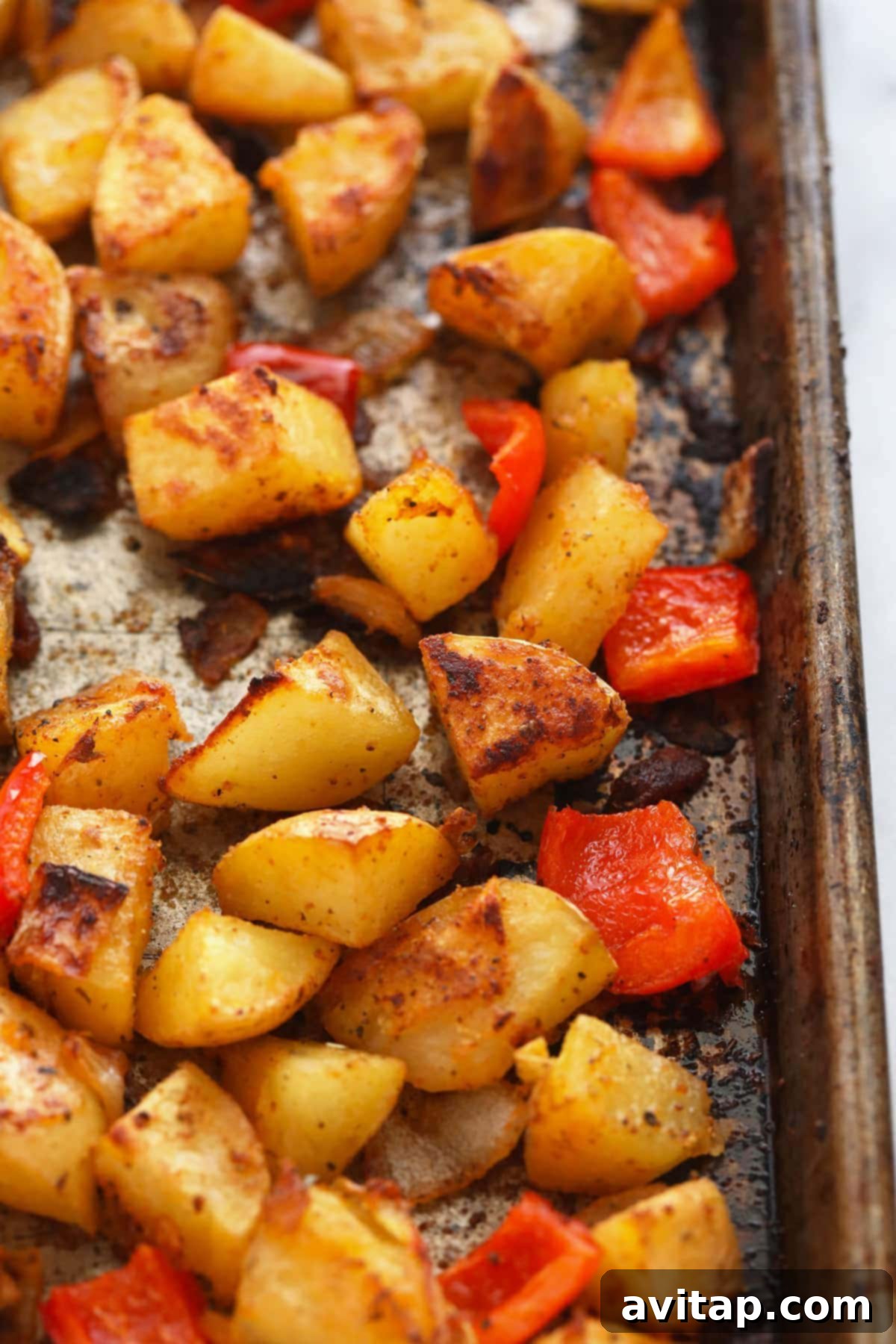 Crispy breakfast potatoes on a baking sheet, golden and delicious