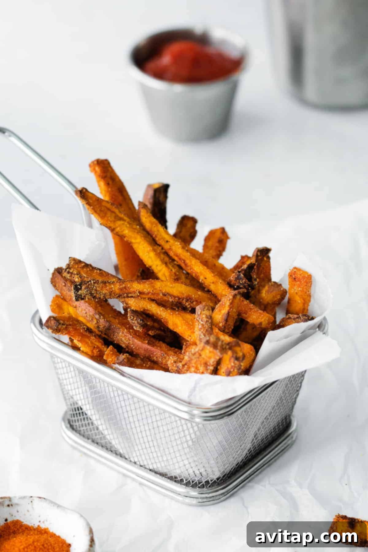 Air-Fried Sweet Potato Perfection 2 Crispy air fryer sweet potato fries in a rustic fry basket, ready to be served