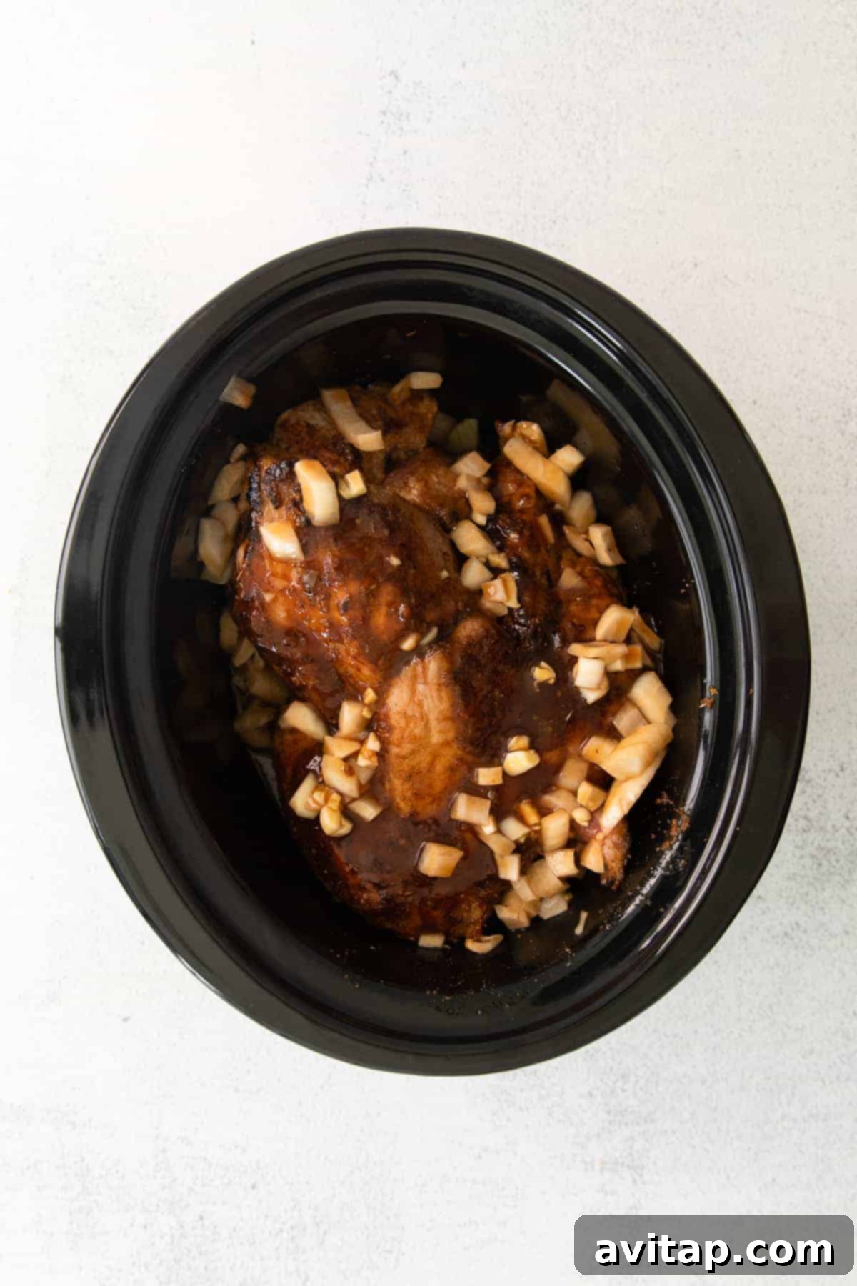 Juicy slow cooker pulled pork simmering to perfection Pulled pork cooking in a slow cooker, looking tender and juicy