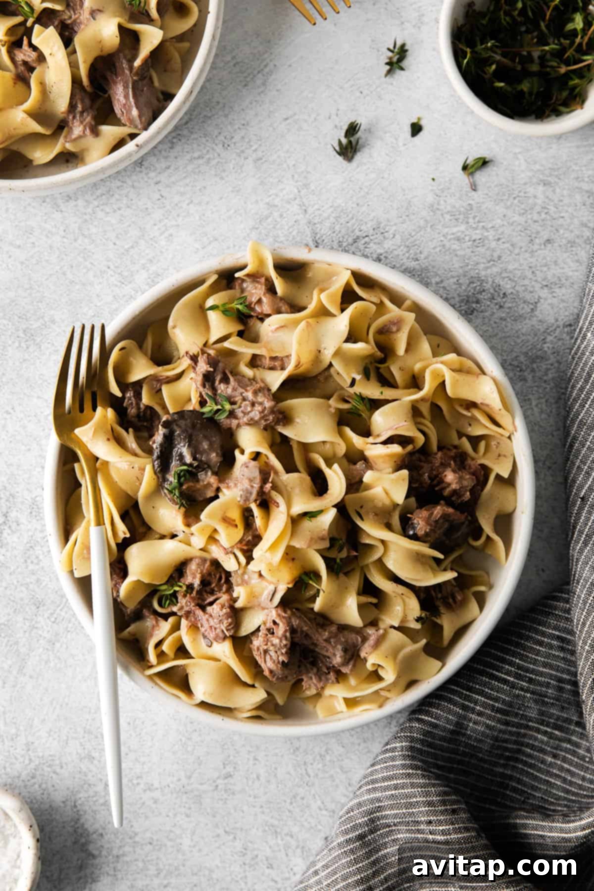 Bowl of beef stroganoff with a fork, ready to eat