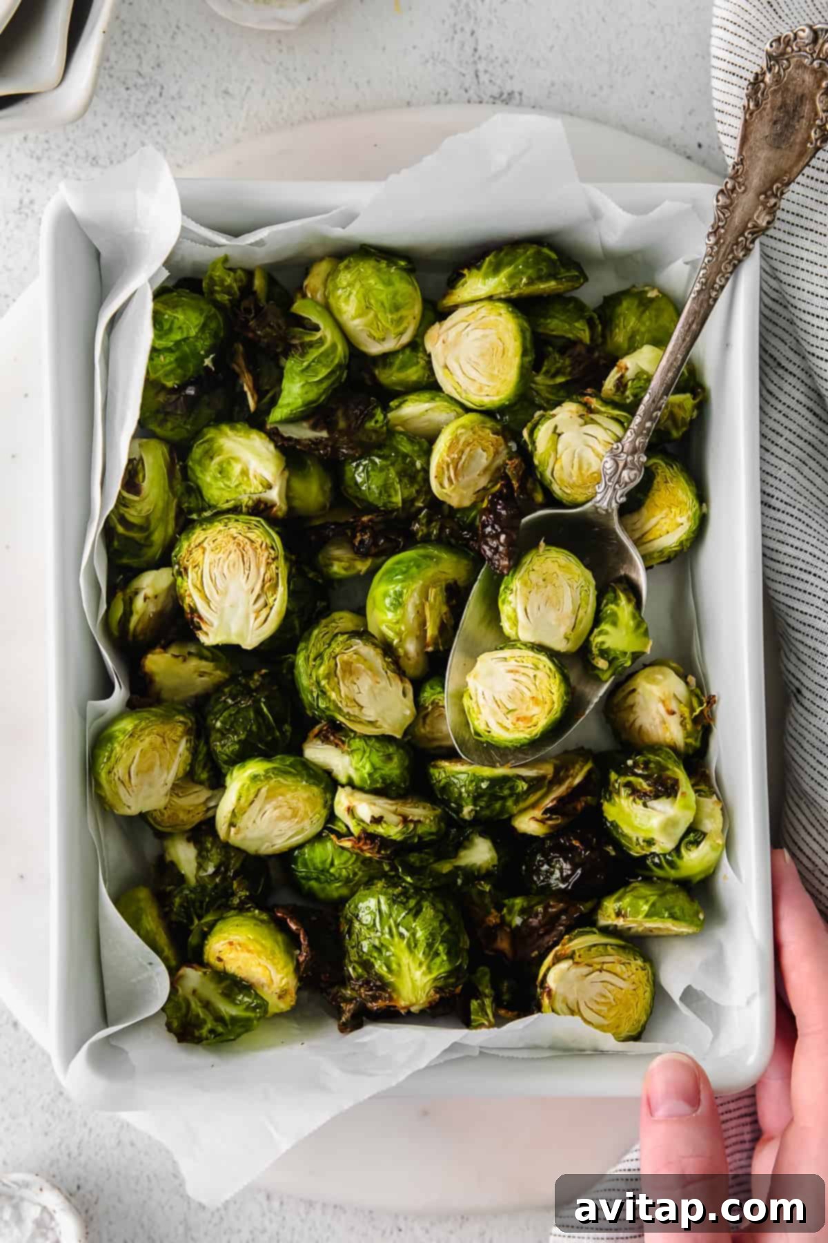 Crispy Air Fryer Brussels Sprouts served in a rustic pan, showcasing their golden-brown exterior and tender interior.