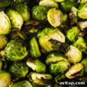 A close up of roasted Brussels sprouts, golden and crispy.