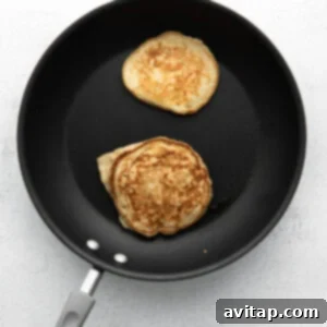Naturally Sweet Banana Flapjacks 5 cooking pancakes on stove.
