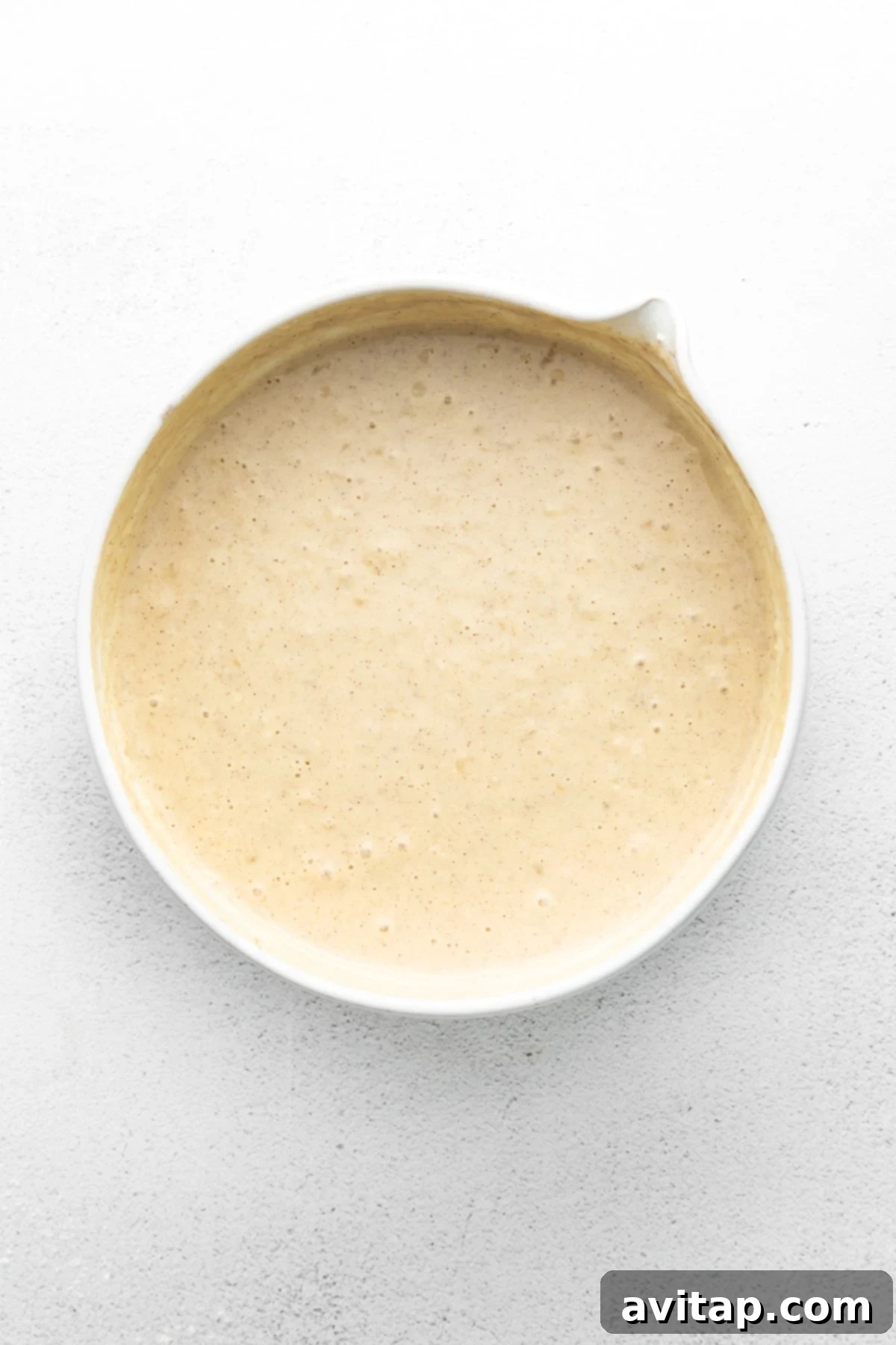 Banana Pancake Batter Ready to Cook Thick, rich banana pancake batter in a mixing bowl, ready for cooking