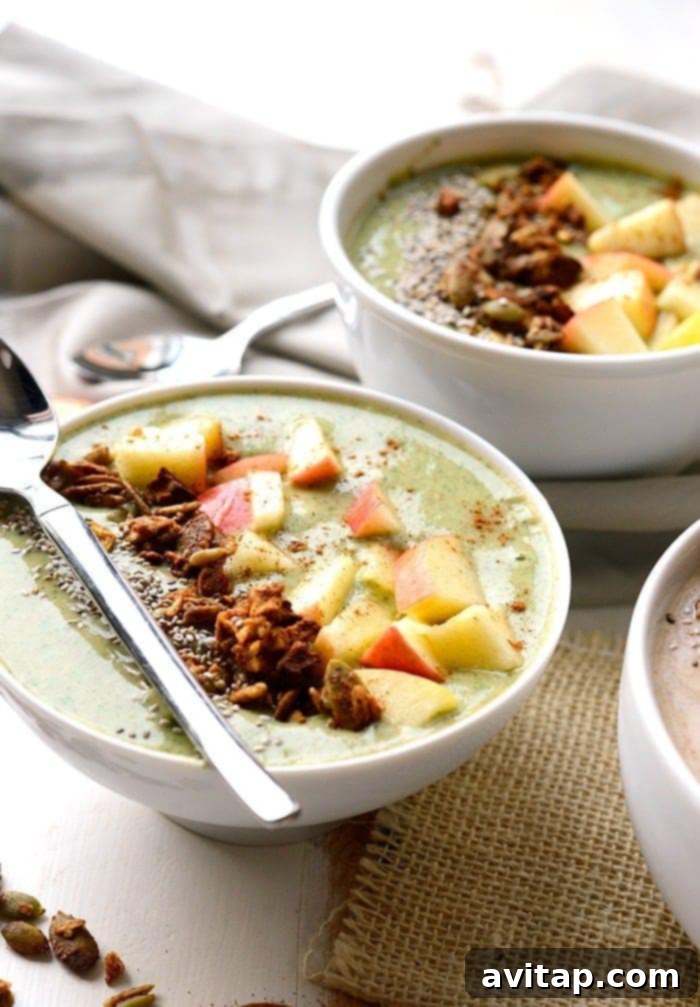 Discover creative topping ideas for your red or green apple pie smoothie bowls. A side-by-side view of two beautifully garnished apple pie smoothie bowls, one with red apple theme and the other green apple, topped with various fruits, nuts, and granola.