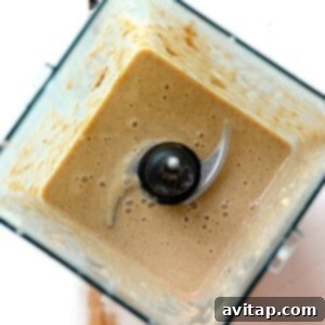 A brown liquid in a blender resembling an apple pie smoothie.