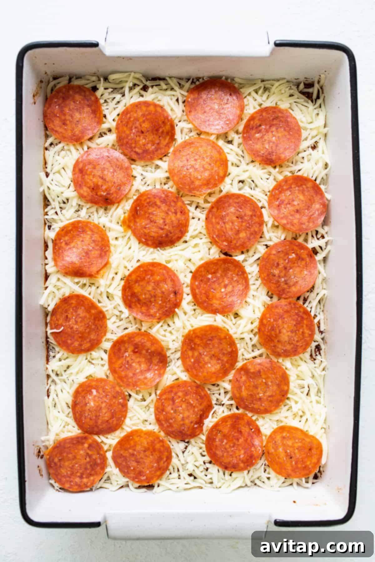 Easy Pizza Quinoa Bake 5 Pepperoni pizza in a baking dish with melted cheese on top, fresh from the oven.