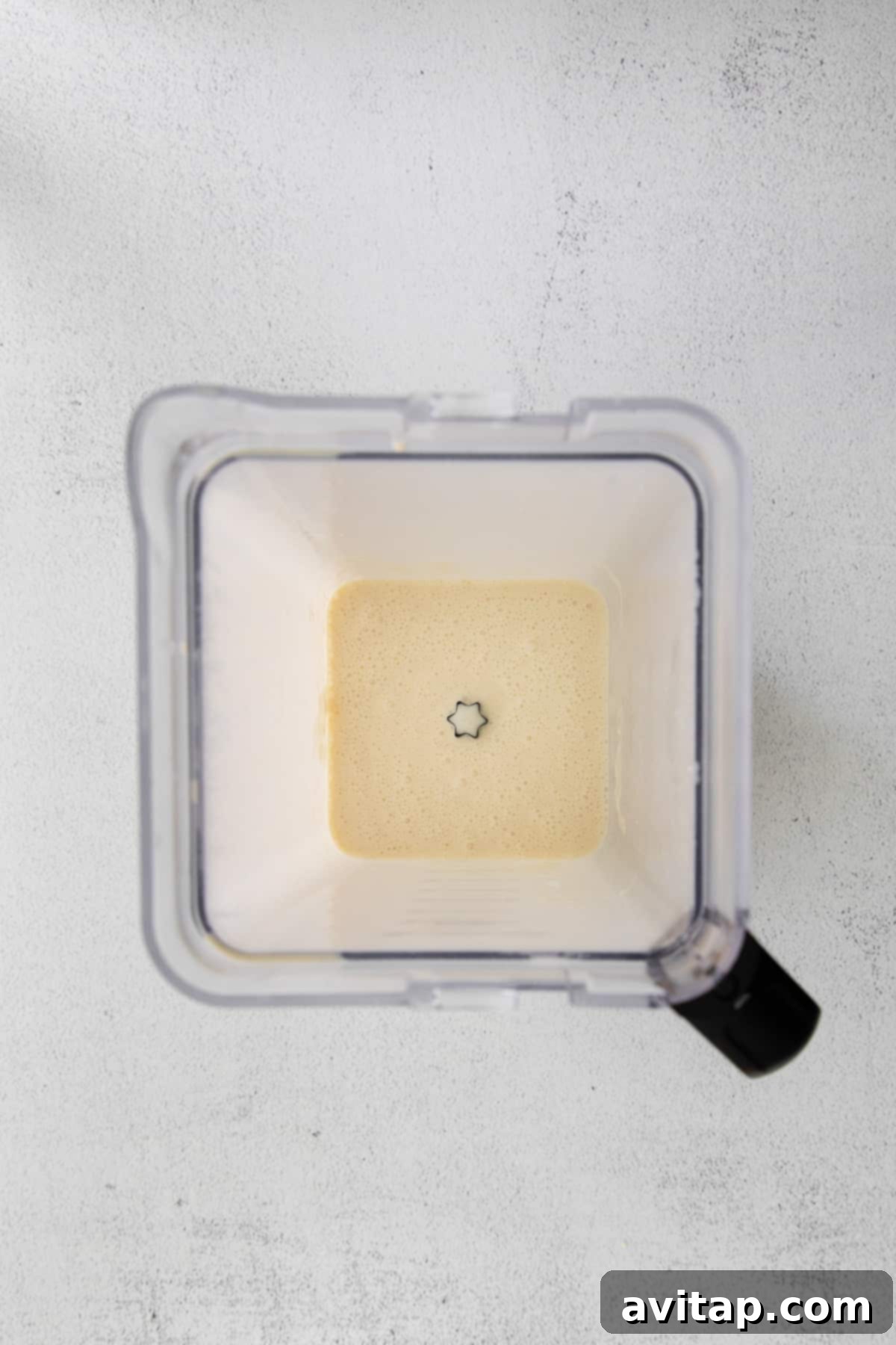 Smooth, thin crepe batter swirled inside a blender jar, ready for cooking.