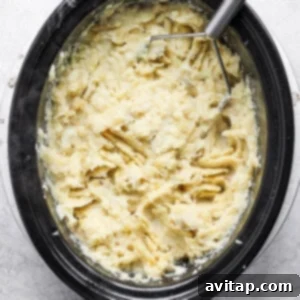 A bowl of mashed potatoes in a slow cooker.