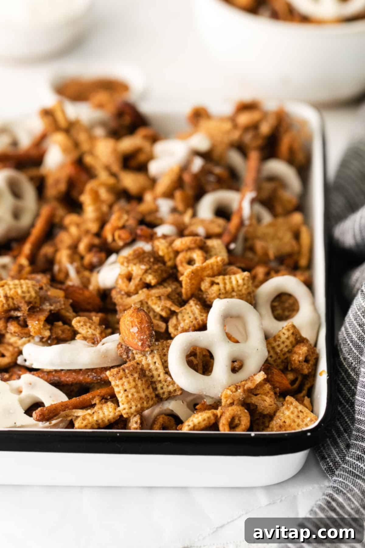 A generous serving of Chai Chex Mix in a bowl, ready to be enjoyed as a perfect autumn snack.
