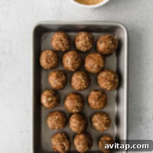 Several pecan pie energy balls resting on a baking sheet, ready for consumption or storage.