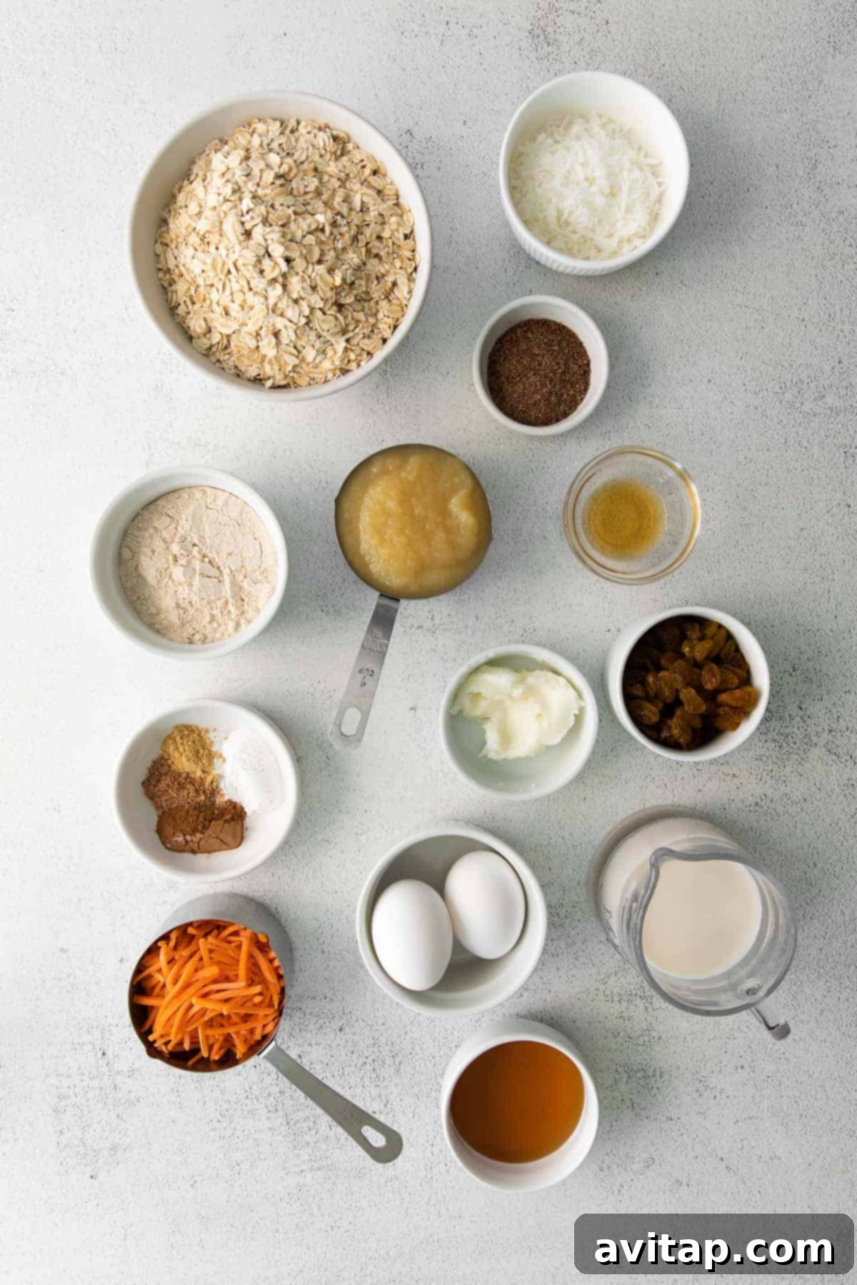 Morning Glory Baked Oatmeal Ingredients All the fresh ingredients for Morning Glory Baked Oatmeal meticulously laid out in bowls, showcasing vibrant carrots, plump raisins, and essential spices, ready to be combined.