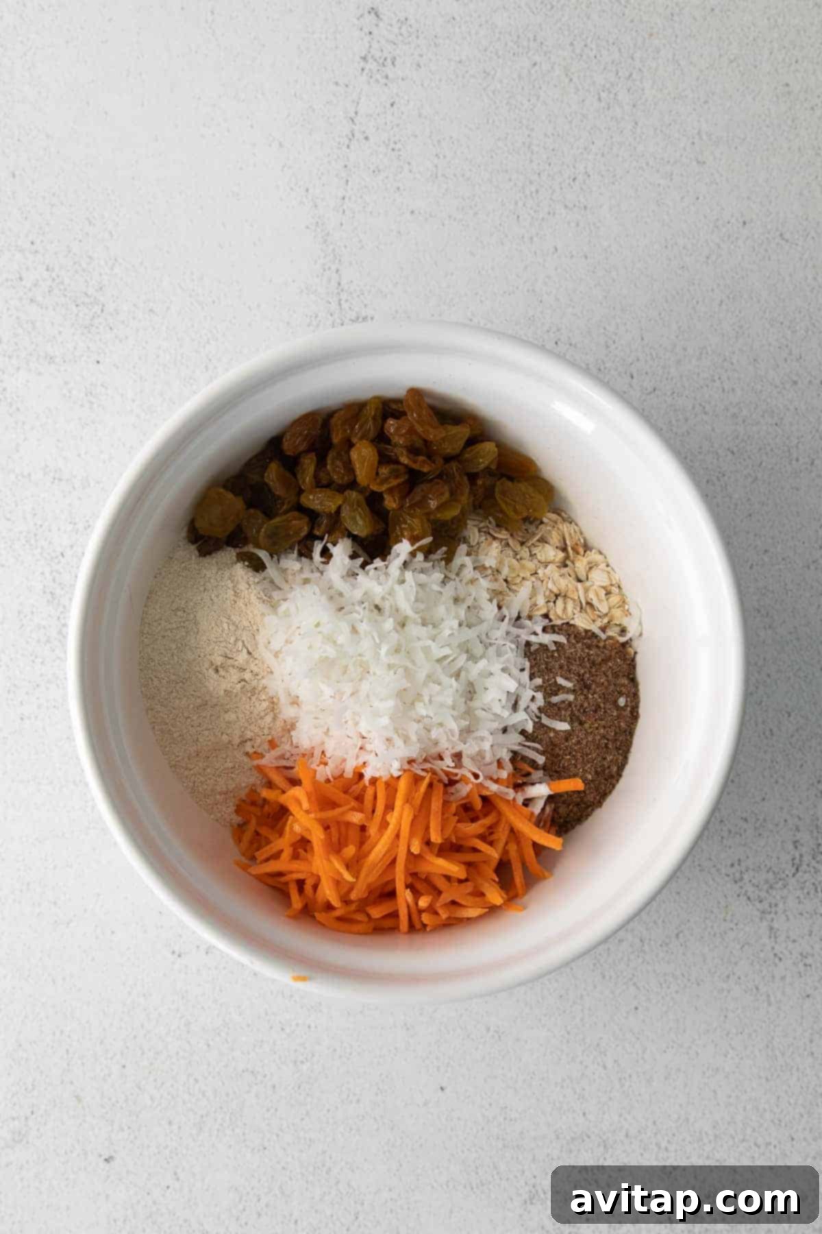 Morning Glory Baked Oatmeal Dry Ingredients Dry ingredients for Morning Glory Baked Oatmeal, including rolled oats, flour, and a vibrant array of spices, neatly arranged in a mixing bowl.