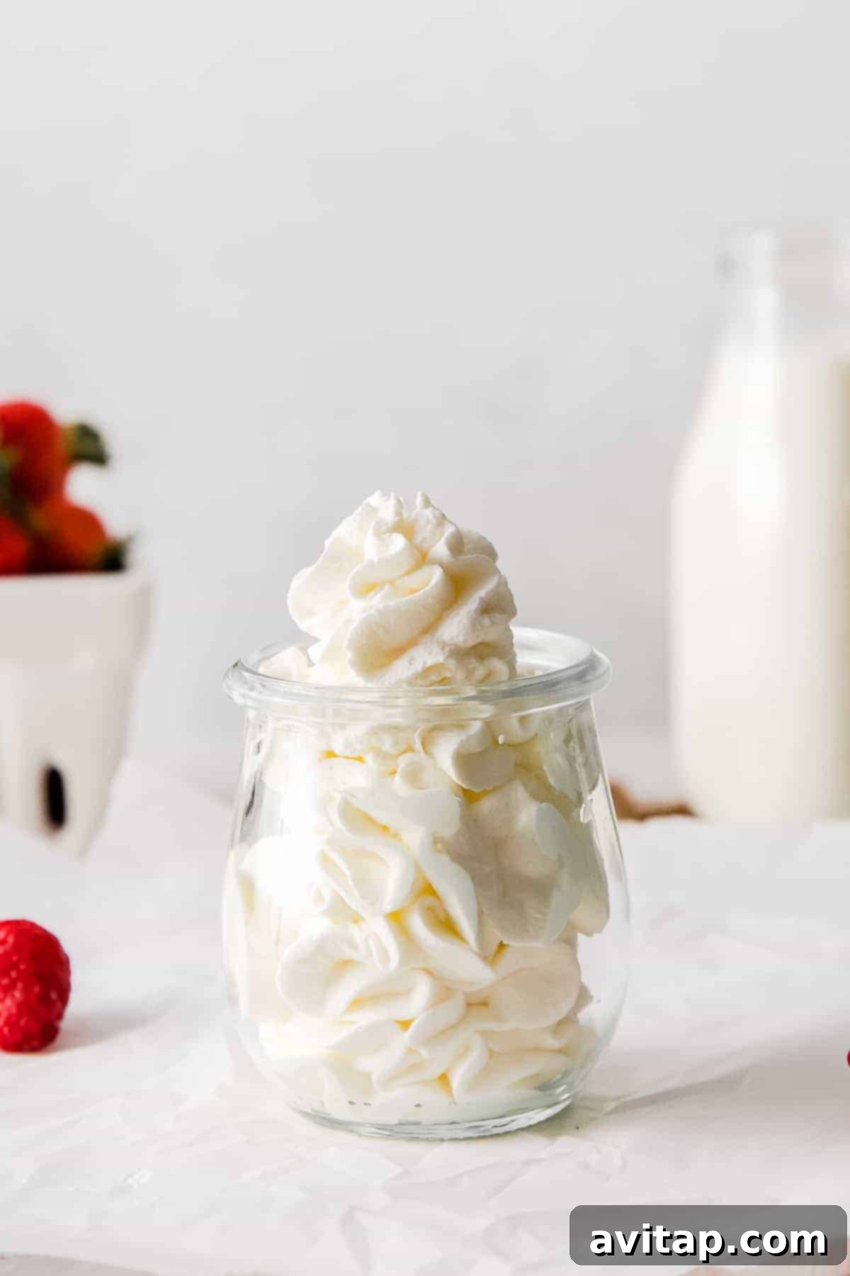 Perfect Homemade Whipped Cream 6 A small glass jar neatly filled with creamy homemade whipped cream, ready for storage or immediate use.