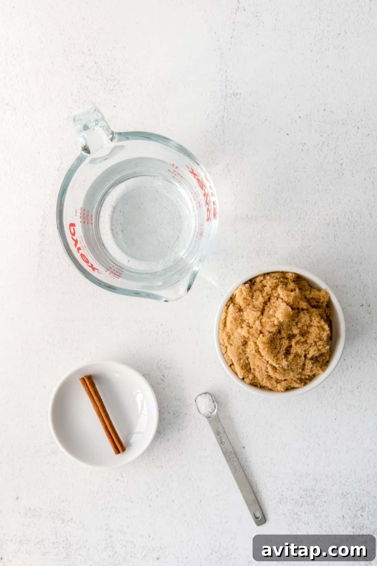 Ingredients for Brown Sugar Simple Syrup Brown sugar and water on a counter, essential for making brown sugar simple syrup.