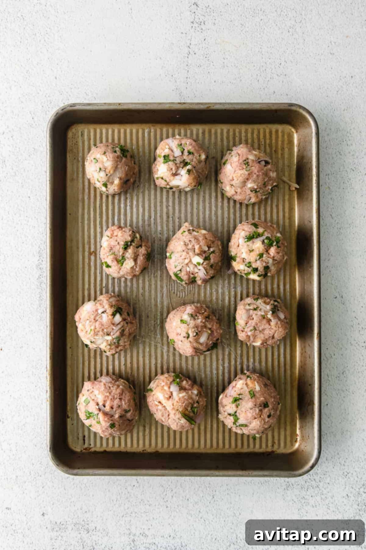 Close-up of golden brown turkey meatballs simmering gently in a vibrant red marinara sauce within a skillet