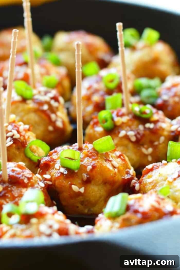 Healthy Kung Pao Meatballs in a serving bowl with chopsticks.