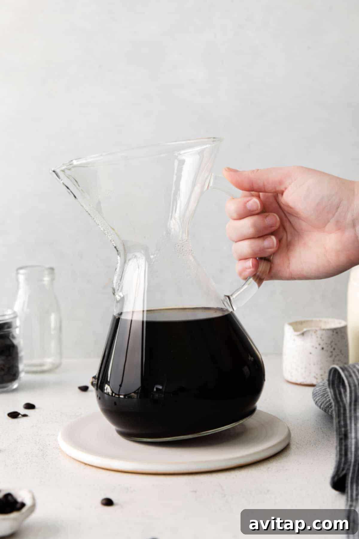 A perfectly brewed cup of pour over coffee in a Chemex, ready to be enjoyed.