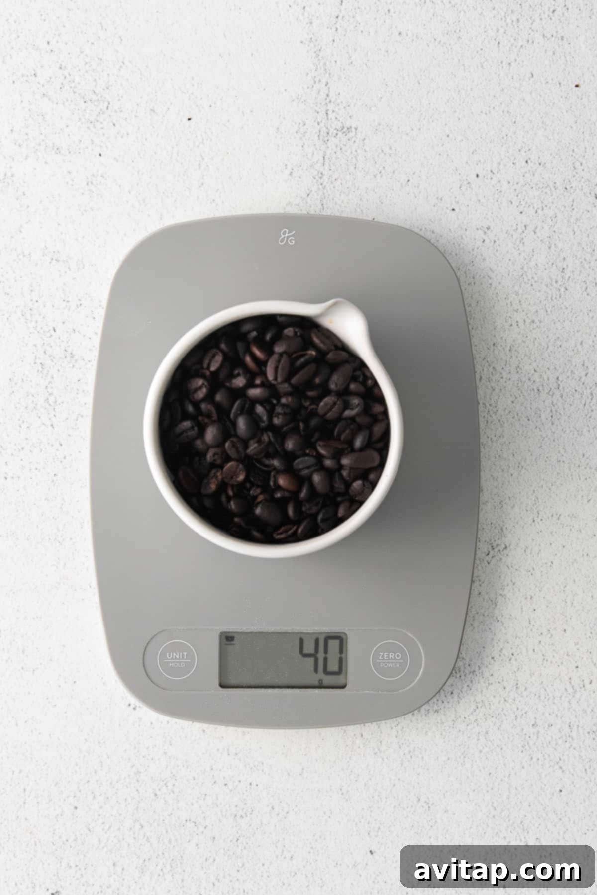 Weighing coffee beans on a digital food scale for precise pour-over brewing.