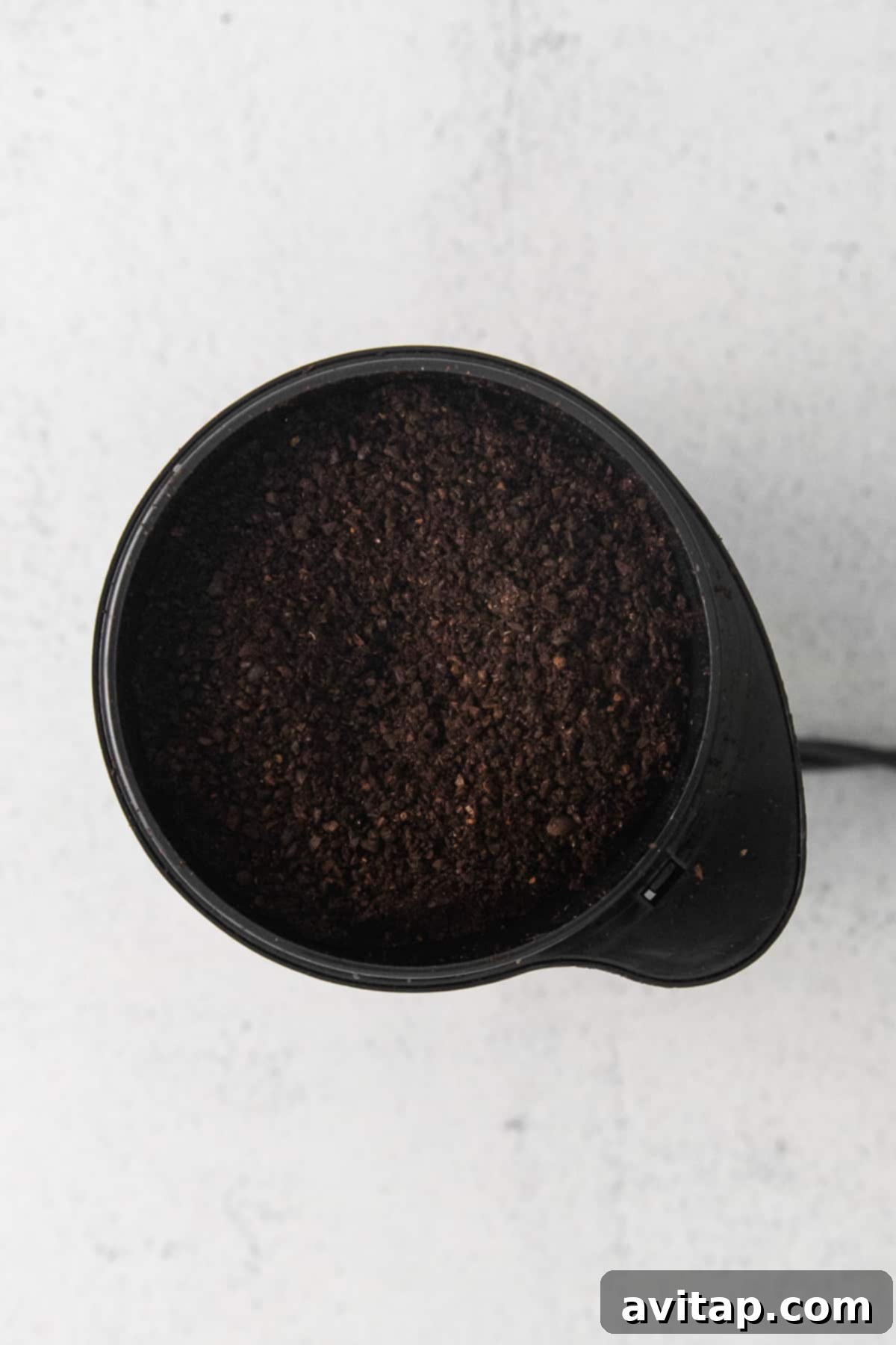 Freshly ground coffee beans, perfectly prepared for pour-over brewing.