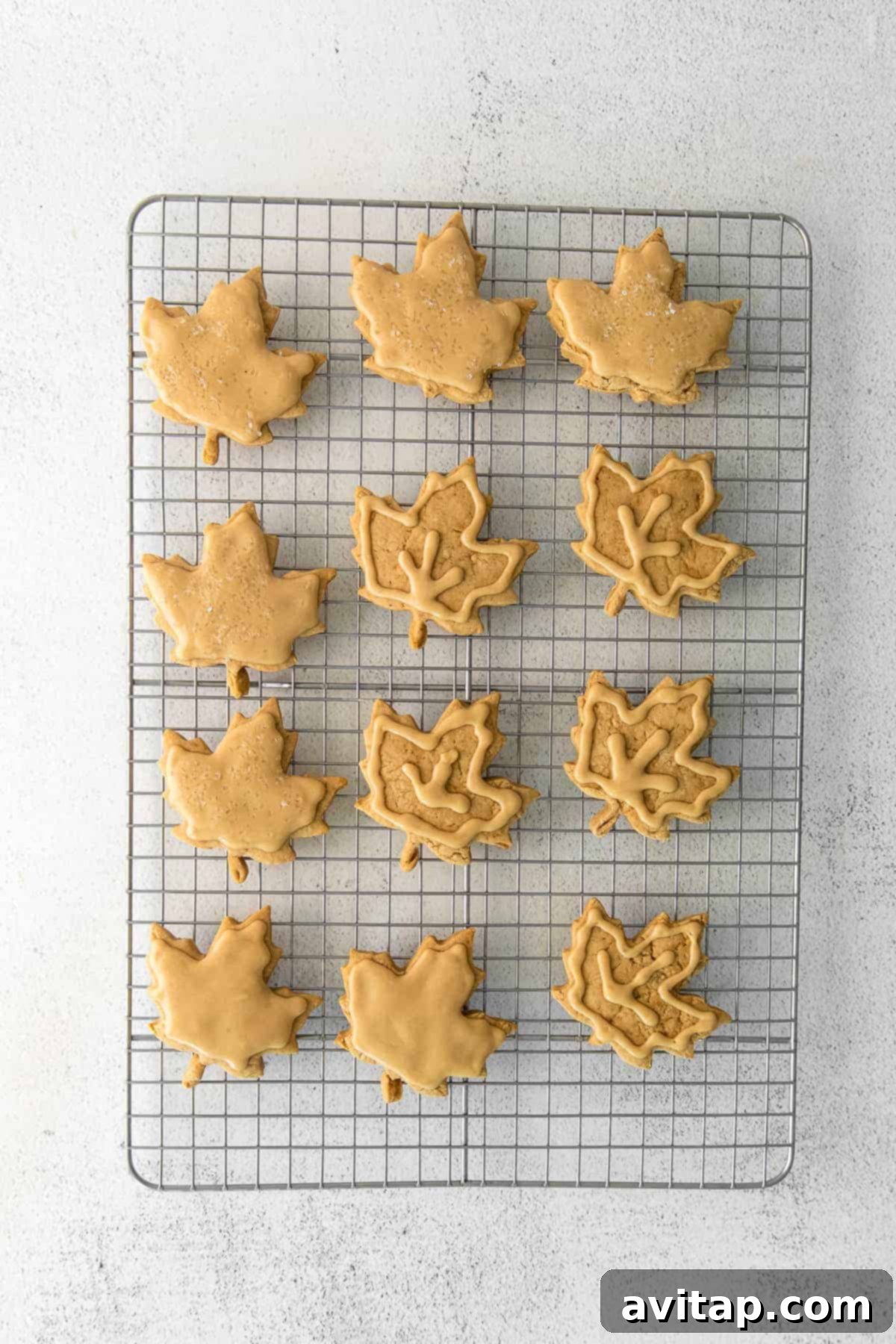 freshly baked maple cookies cooling on a wire rack, ready for frosting