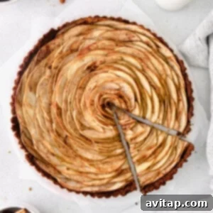 A beautifully baked apple tart featuring a delicate apple rose on a gingersnap crust.