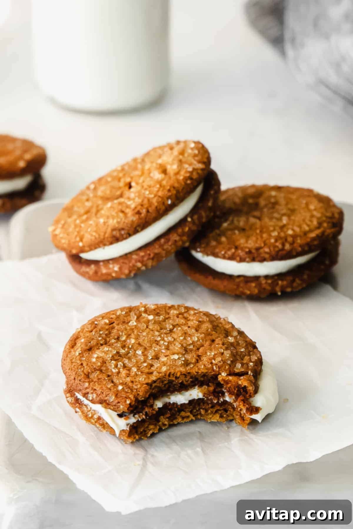 Stacked ginger molasses whoopie pies with creamy filling visible, ready to be enjoyed.