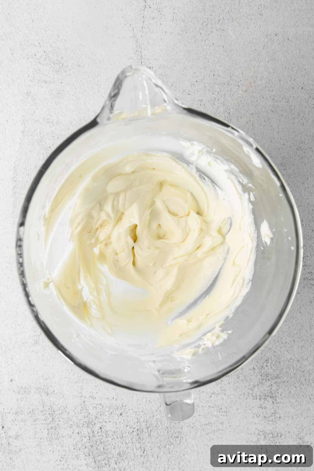 Close-up of luscious, fluffy cream cheese whoopie pie filling in a mixing bowl, perfectly whipped.