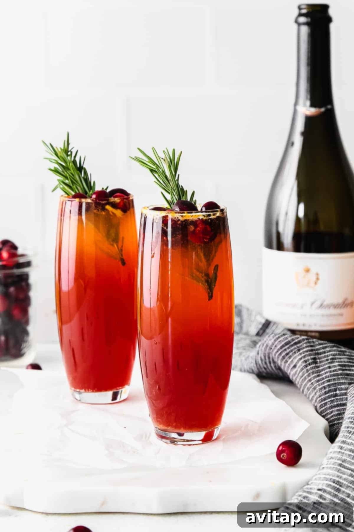 Close-up of a Cranberry Mimosa showing its vibrant color and delicate bubbles.