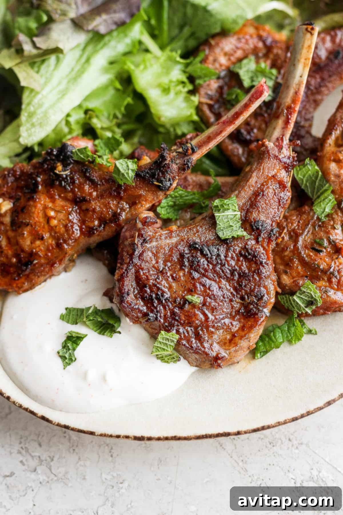 pan seared lamb chop plated over a homemade aioli