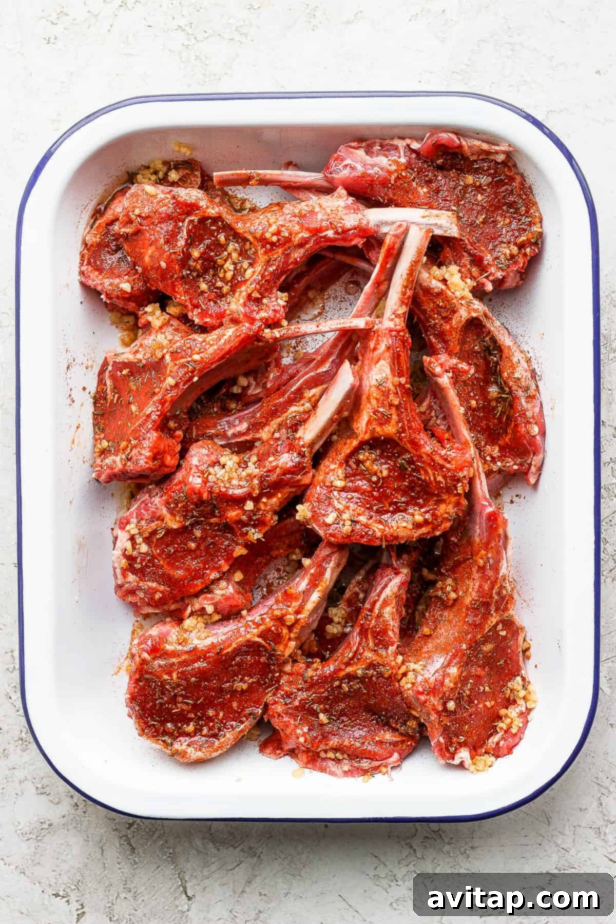 raw lamb chops seasoned with a dry rub