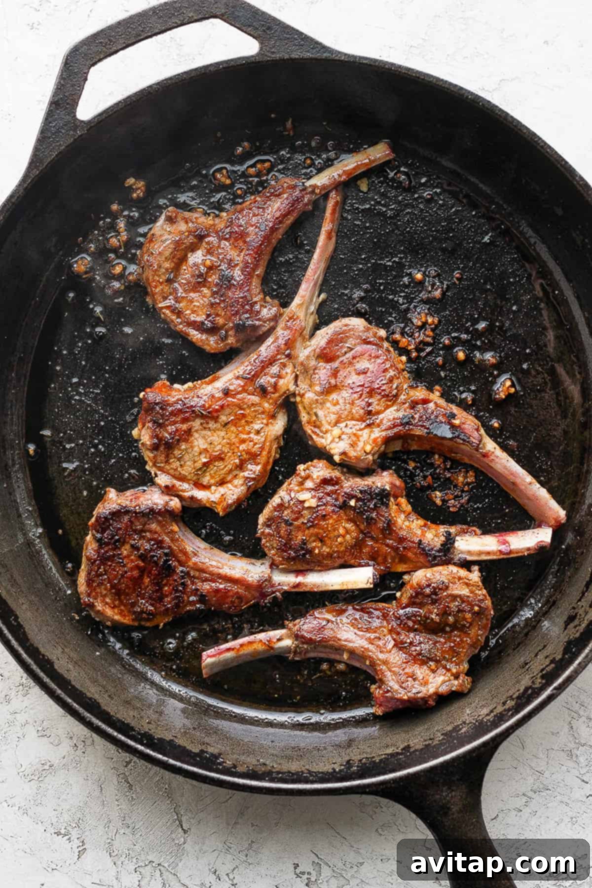 pan seared lamb chops in a cast iron skillet