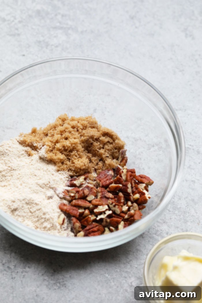 Key ingredients for an Overnight French Toast Bake, including sourdough bread, fresh eggs, maple syrup, and pecans, arranged in a rustic bowl.