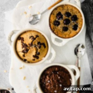 Blended baked oatmeal in ramekins, cooling after baking, topped with fresh fruit.