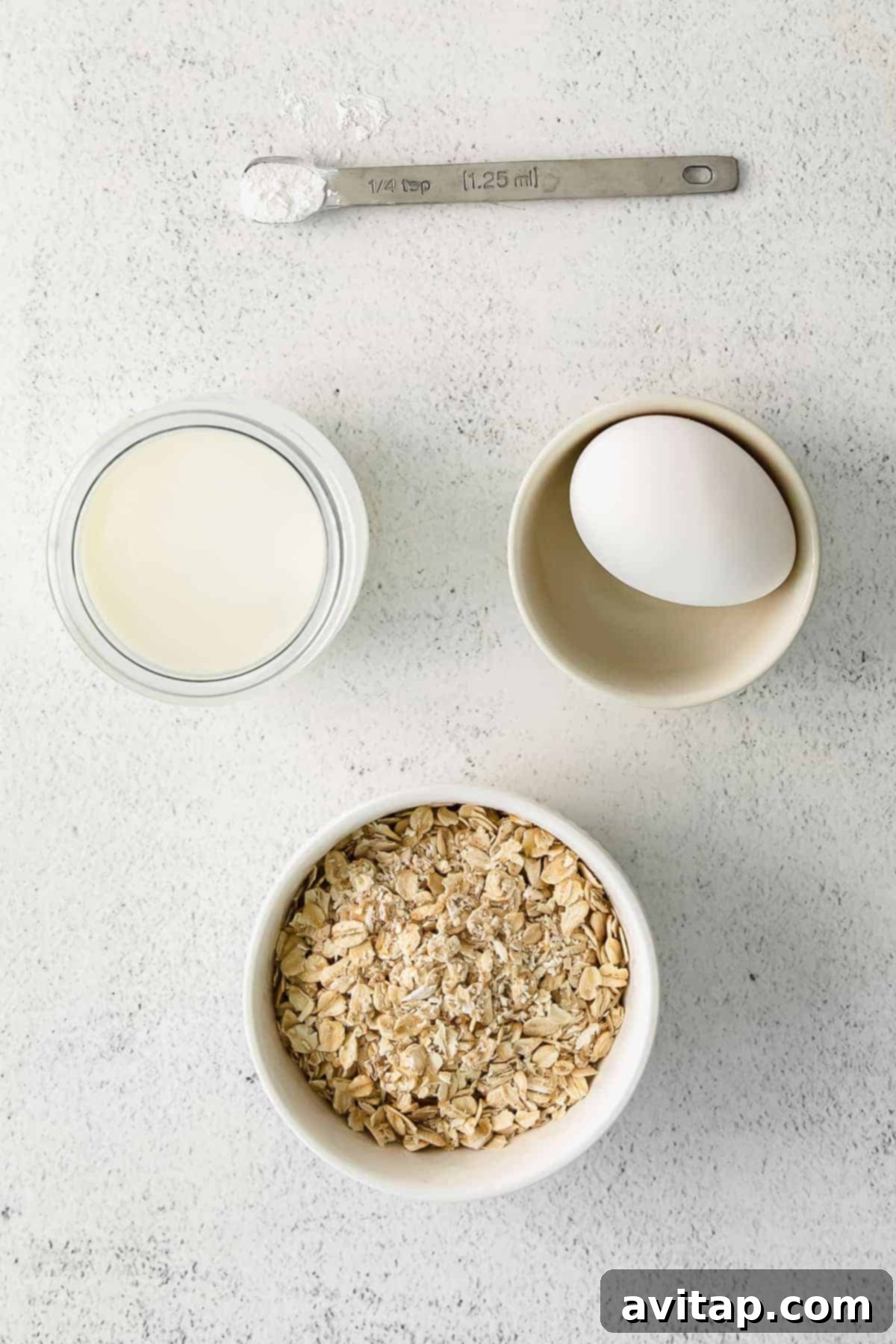 Fresh Ingredients for Delicious Blended Baked Oats Key ingredients for blended baked oatmeal laid out in individual bowls, including oats, milk, and eggs, ready for mixing.