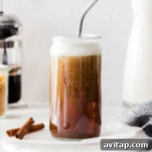 Refreshing iced shaken espresso drink in a glass with ice and a straw.