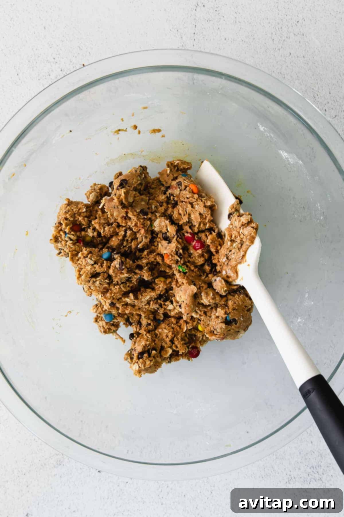 Cookie dough mixture in a bowl, ready to be rolled into protein balls.