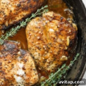 A top-down view of garlic butter chicken in a skillet, ready to be served.
