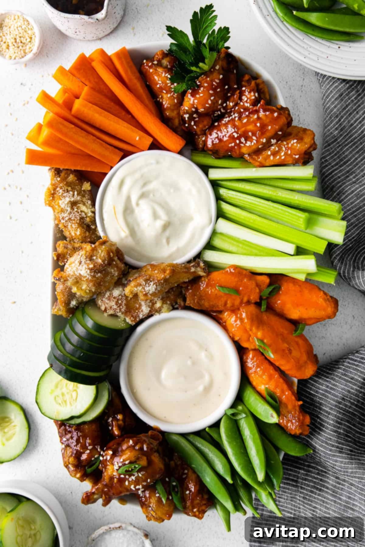 Air fryer chicken wings, veggies, and dips on platter.
