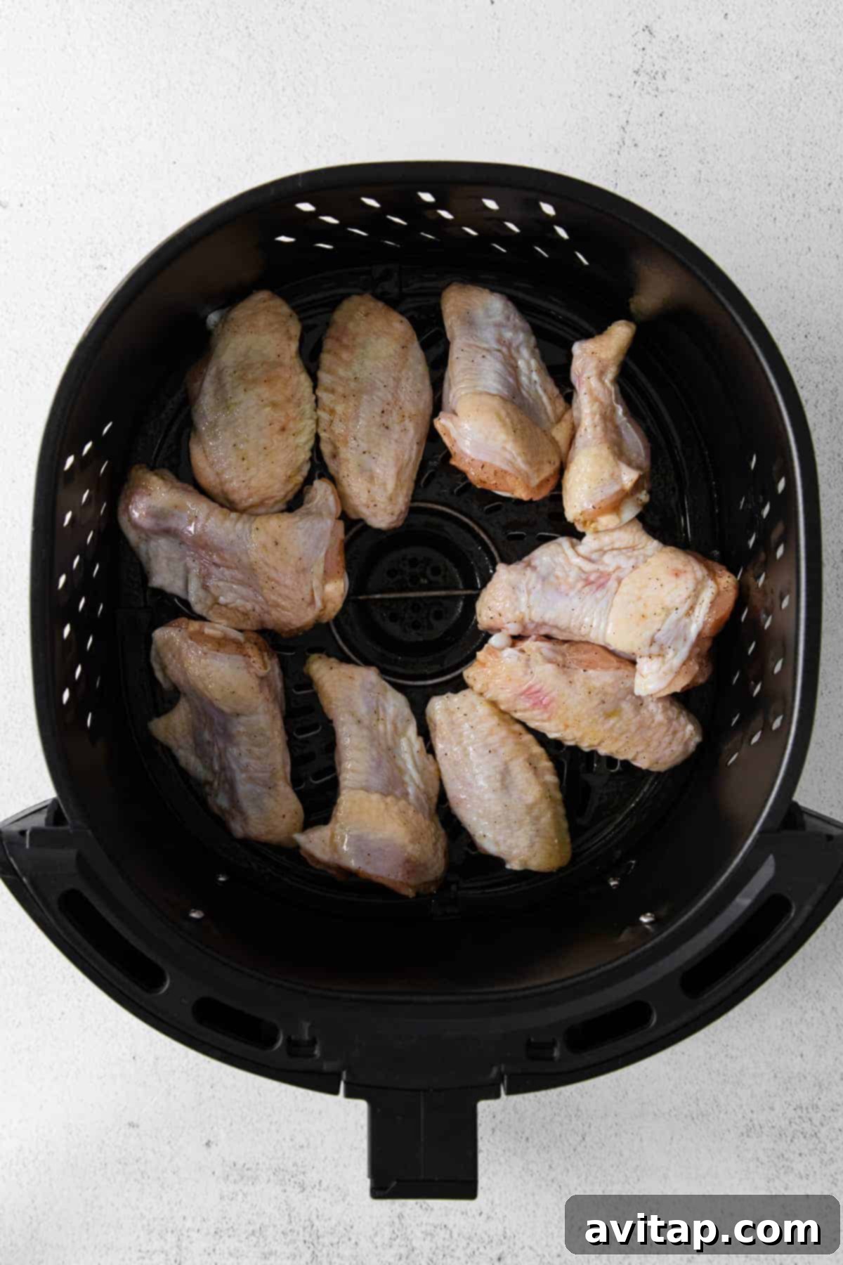 Raw chicken wings in the air fryer. 