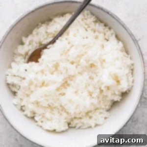 Perfectly cooked sticky rice in a small white bowl, ready to be served.