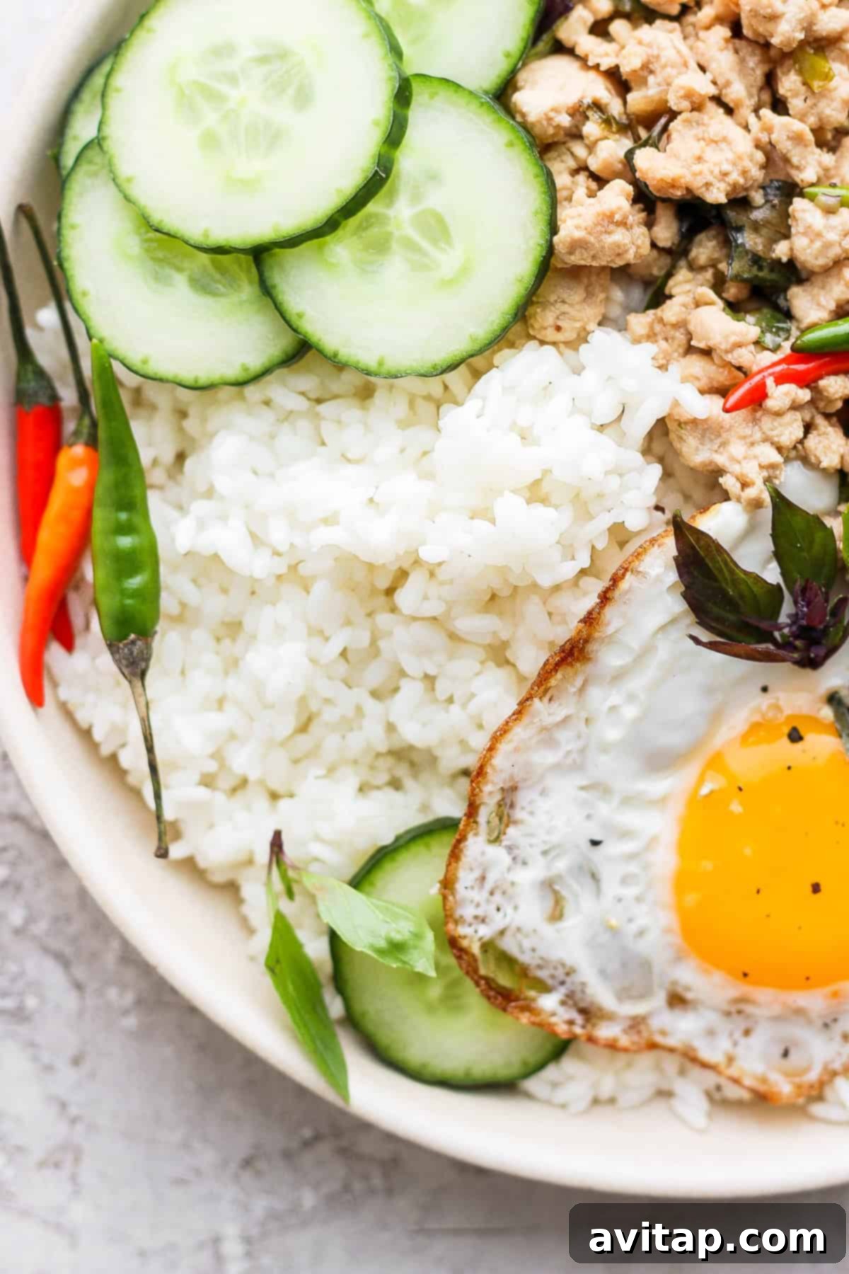 Sticky rice is a very versatile recipe to pair with many Asian-inspired dishes. Make sticky rice in your own kitchen with our step by step instructions. Enjoy! A bowl of sticky rice served alongside vibrant Pad Krapow, a perfect example of a savory pairing.