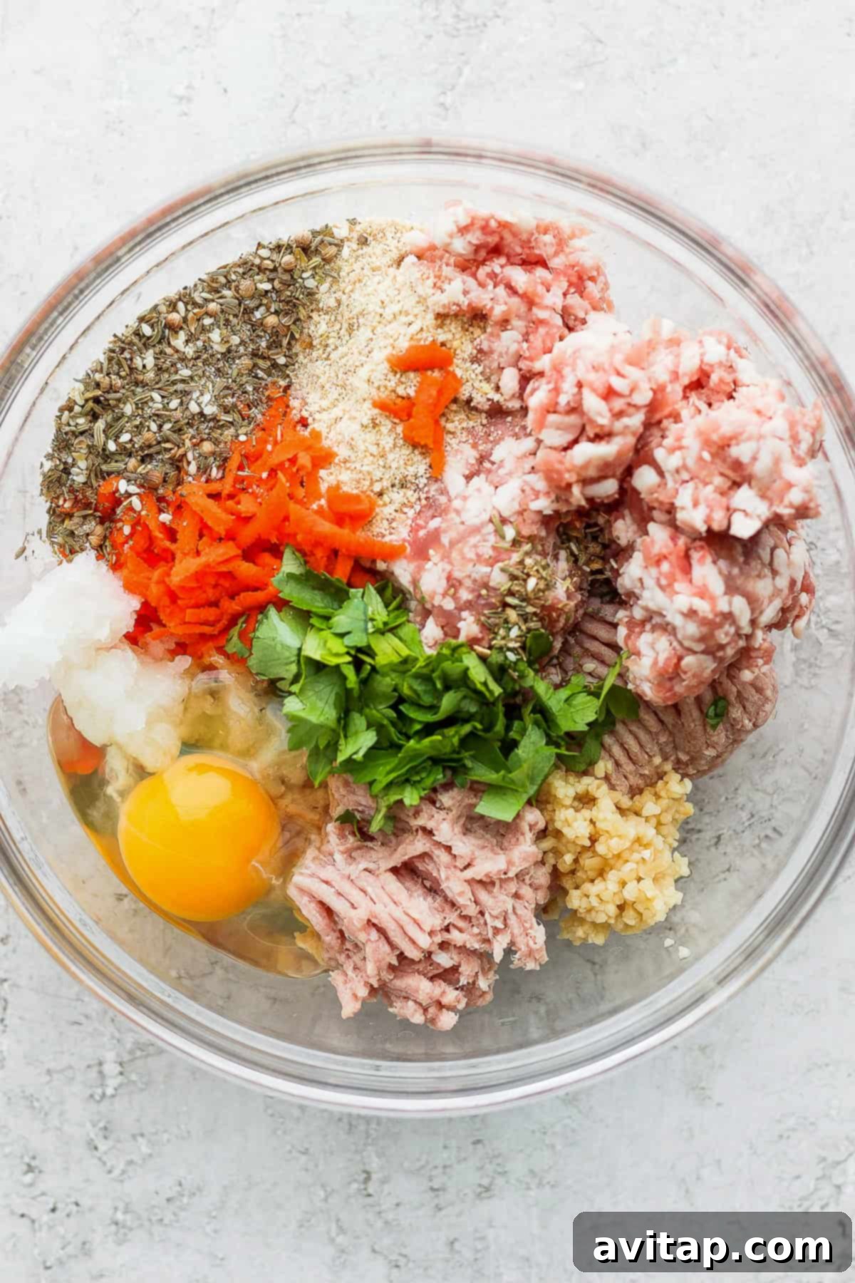 A collection of fresh, high-quality ingredients for One-Pot Za'atar Meatballs and Quinoa arranged in bowls.