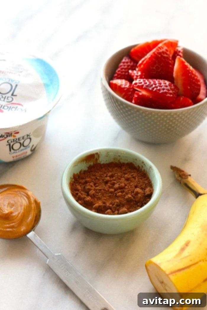 Simple Mousse Ingredients Key ingredients for healthy chocolate peanut butter mousse: a bowl of vanilla Greek yogurt, cocoa powder, and a spoonful of peanut butter