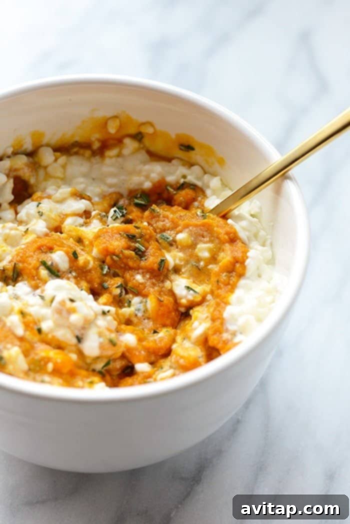 A bowl filled with the creamy, orange sweet potato and cheese mixture, ready to be spread as a flavorful layer in the lasagna.